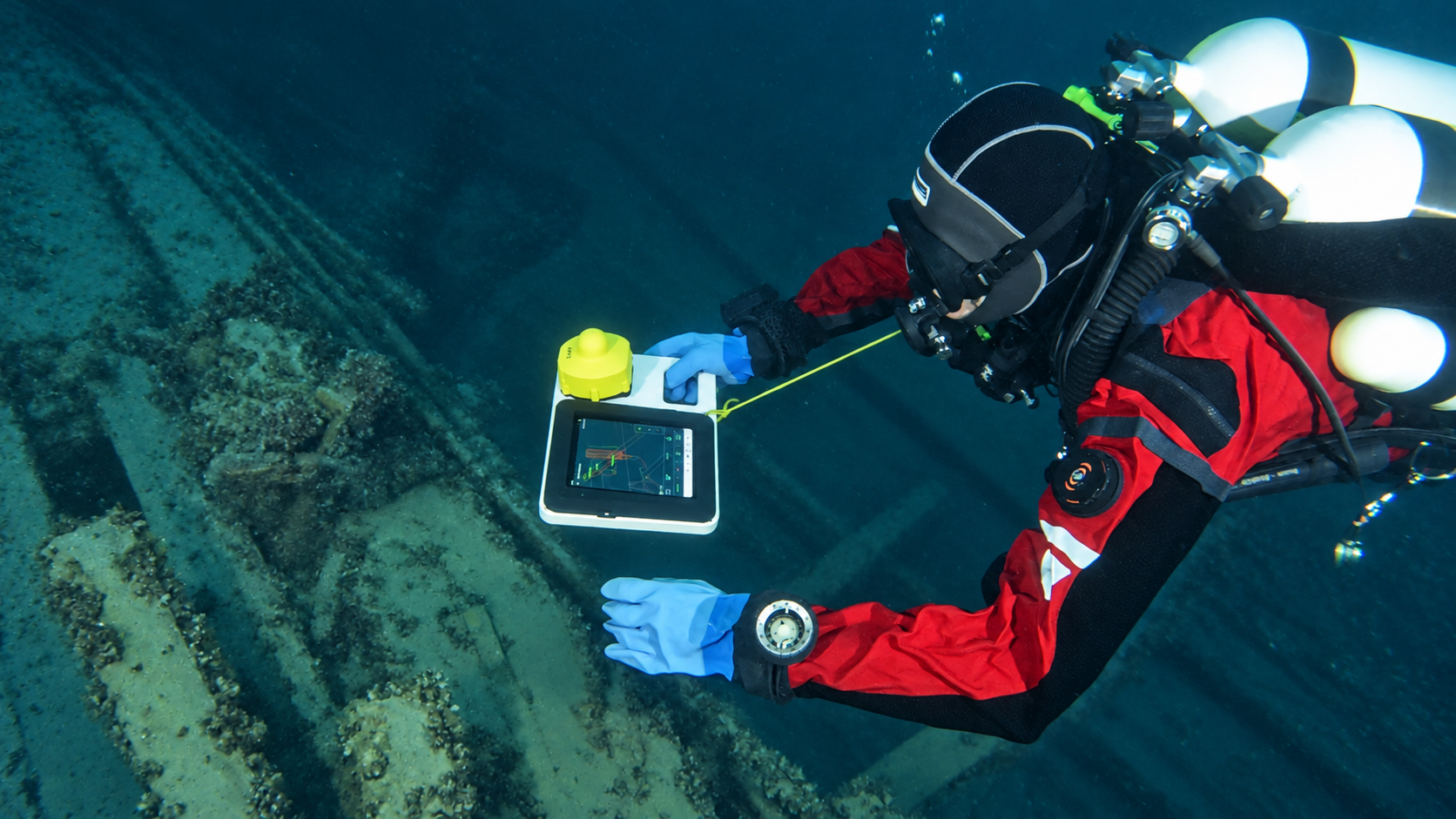 Diver using an underwater navigation tablet with a UWIS unit